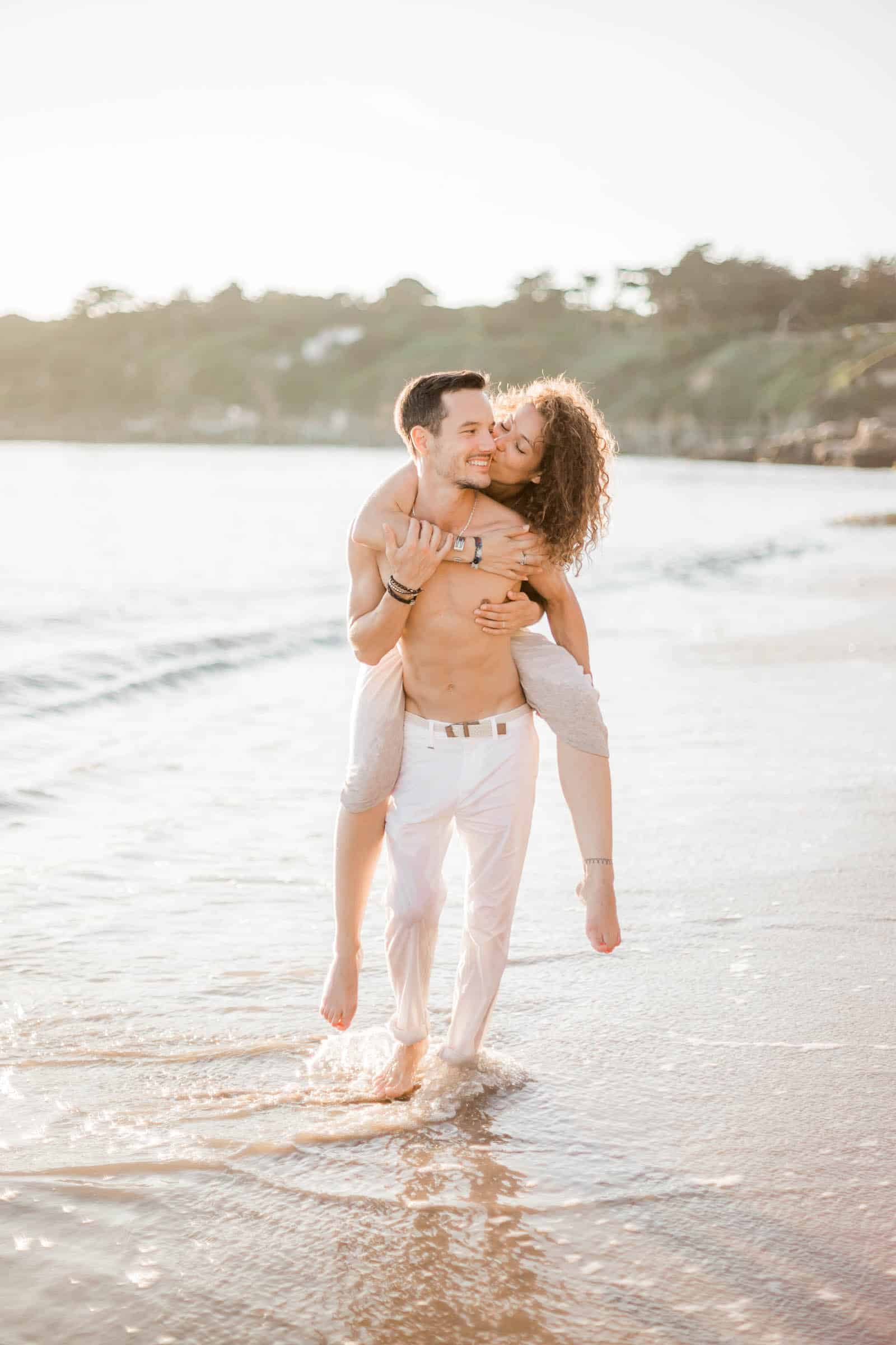 Photographie de Mathieu Dété présentant un couple heureux marchant en bord de mer et en train de rigoler