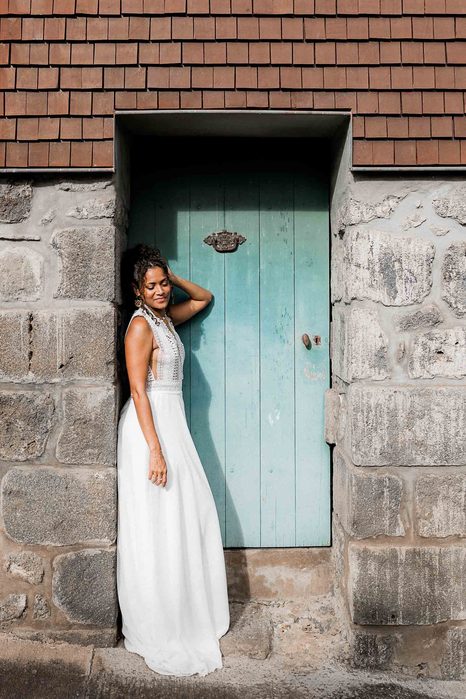 Photographie de Mathieu Dété, photographe de mariage et famille à Saint-Pierre sur l'île de la Réunion 974, présentant une modèle dans une robe de mariée devant un mur du Jardin Botanique Mascarin de Saint-Leu