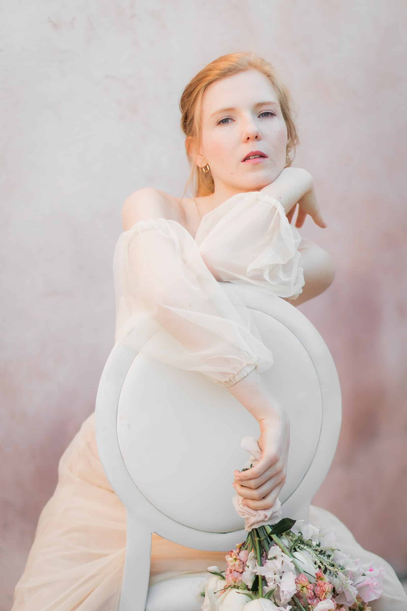 Photographie de Mathieu Dété présentant la mariée assise à la table fleurie du Château Saint Julien d'Aille à Vidauban